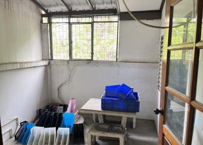 A well-lit utility room with a table and storage crates