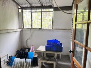 A well-lit utility room with a table and storage crates