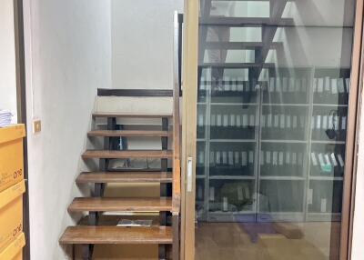 Staircase with a glass partition and adjacent office space