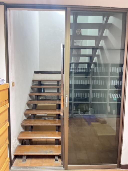 Staircase with a glass partition and adjacent office space