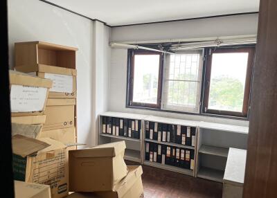 A small room with boxes and office files