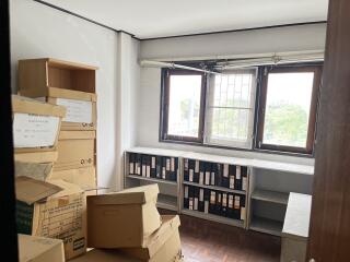 A small room with boxes and office files