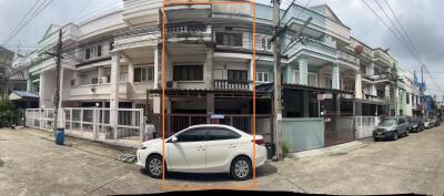 Exterior view of a residential building with parked cars