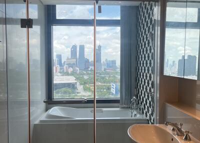 Modern bathroom with a large window offering a city view