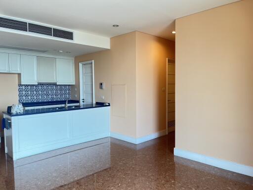 Modern kitchen with white cabinetry and patterned backsplash