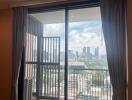 Living room with large windows and balcony view of the city skyline