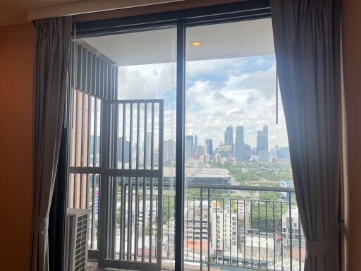 Living room with large windows and balcony view of the city skyline