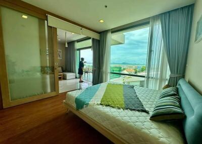 Spacious bedroom with a large window and a scenic view