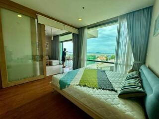 Spacious bedroom with a large window and a scenic view