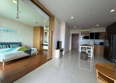 Open plan studio apartment with a bedroom, kitchen, and living area.