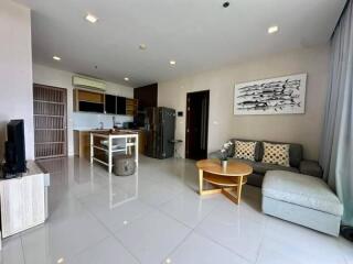 Spacious living room with modern decor and open kitchen.