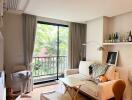 Bright and cozy living room with a large window, a beige sofa, a small table, and decorative items