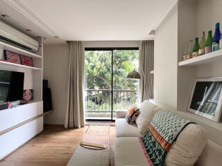 Spacious living room with a large window and modern decor.