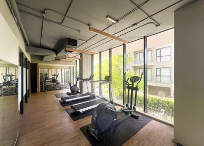 Well-equipped modern gym with workout machines and large windows