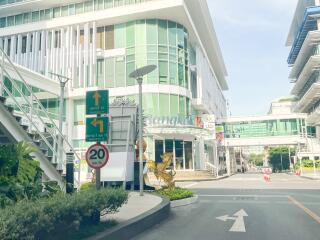 Modern commercial building exterior with signage and landscaping