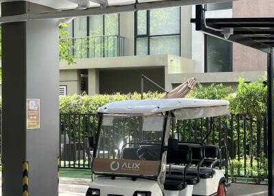 Outdoor parking area with a golf cart