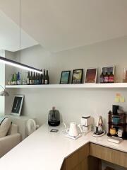 Modern kitchen with counter, appliances, and decorative shelf