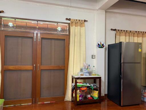 Kitchen with double wooden doors and refrigerator