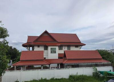 Two-story house with red tile roof