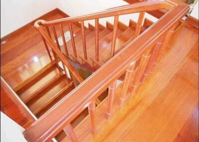 Wooden staircase with polished railing