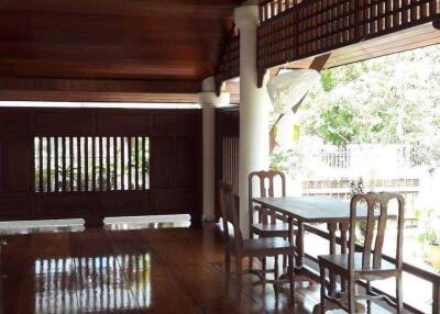 Spacious wooden patio area with a dining set