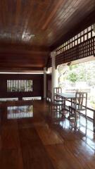 Spacious wooden patio area with a dining set