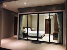 Bedroom with sliding glass doors and modern lighting