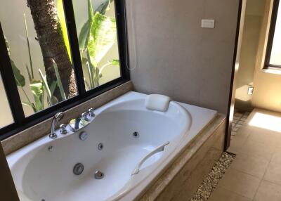 Bathroom with a bathtub and window view