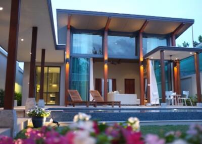 Modern house exterior with pool and outdoor seating