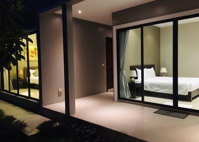 Bedroom with sliding glass doors leading to an outdoor patio