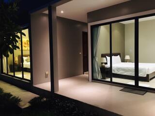 Bedroom with sliding glass doors leading to an outdoor patio