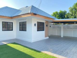 Exterior view of a house with a driveway and a car port