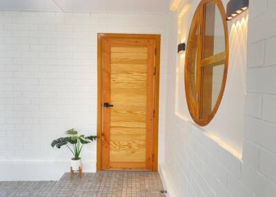 Hallway with wooden door and decorative mirror