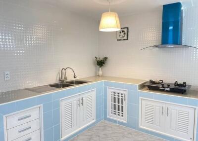 Modern kitchen with blue and white cabinets and gas stove
