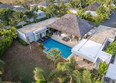 Aerial view of a modern villa with a swimming pool and garden