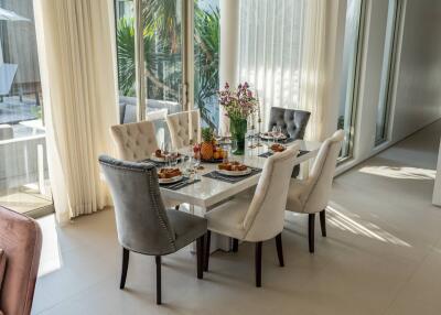 Elegant dining area with set table and garden view