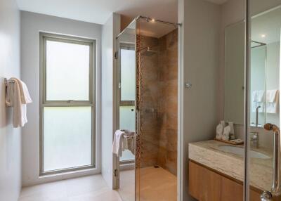 Modern bathroom with glass shower and large window