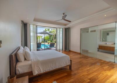Spacious bedroom with pool view and modern amenities