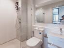 Modern bathroom with glass shower and white fixtures