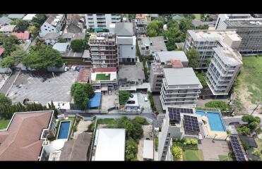 Aerial view of a residential neighborhood with various buildings and amenities