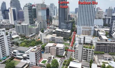 Aerial view of a cityscape with various buildings including the Carlton Hotel and Radison Blu.
