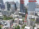 Aerial view of a cityscape with various buildings including the Carlton Hotel and Radison Blu.