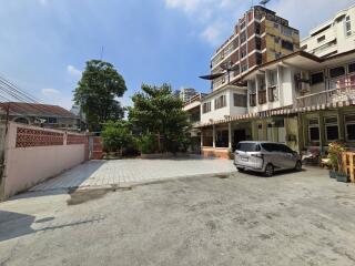 Exterior view of a residential building with parked cars