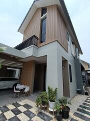 Modern two-story house with a driveway and garden