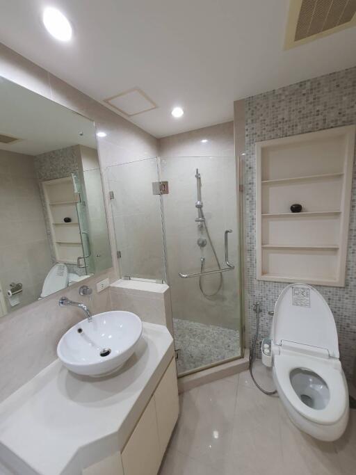 Modern bathroom with a shower, toilet, and sink