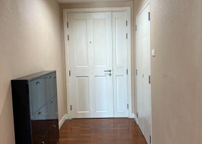Clean hallway with wooden floors and white doors