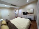 Master bedroom with TV, dresser, and comfortable lighting