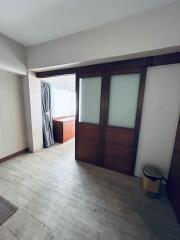 Room with sliding doors and a window with curtains