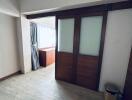 Room with sliding doors and a window with curtains