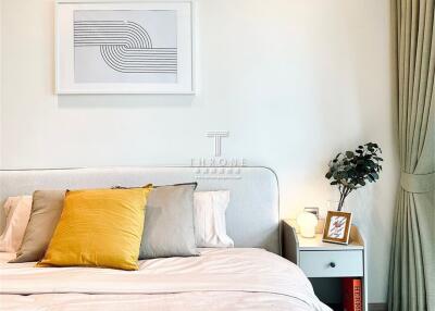 Bedroom with bed, side table, and wall art